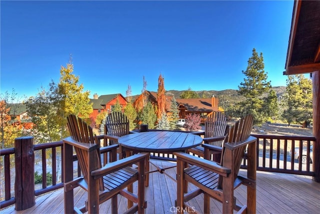 wooden terrace with outdoor dining space