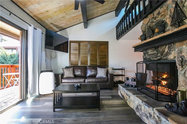 living room featuring wood finished floors, vaulted ceiling with beams, a fireplace, ceiling fan, and wooden ceiling