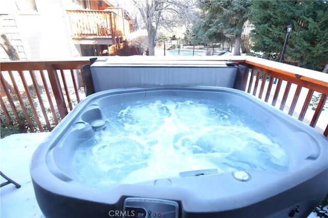 view of pool with a covered hot tub