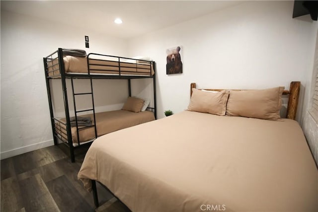 bedroom with dark wood finished floors, recessed lighting, and baseboards