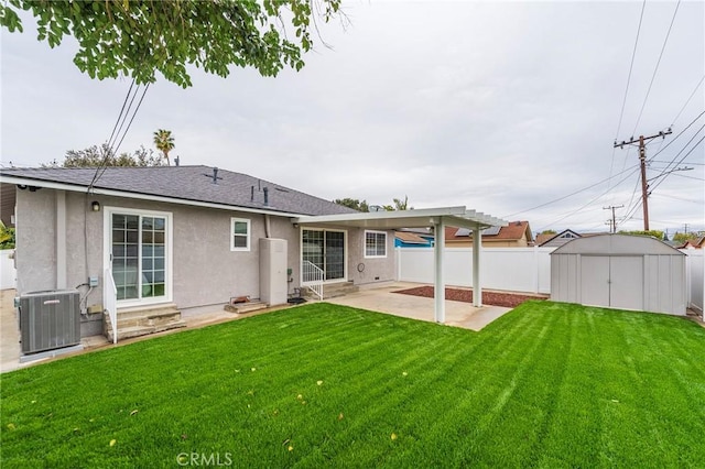 back of property featuring stucco siding, fence, a shed, an outdoor structure, and a patio area