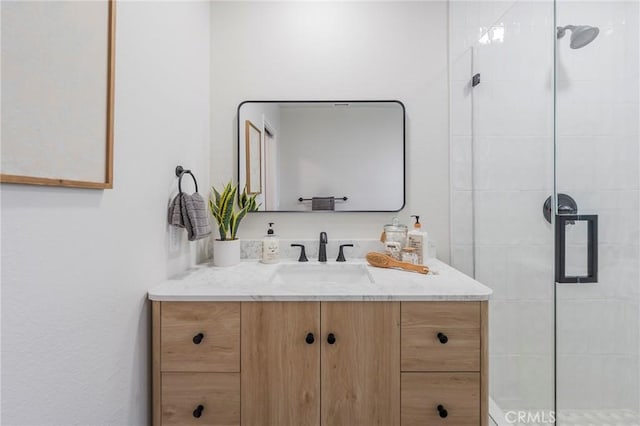 bathroom featuring a stall shower and vanity