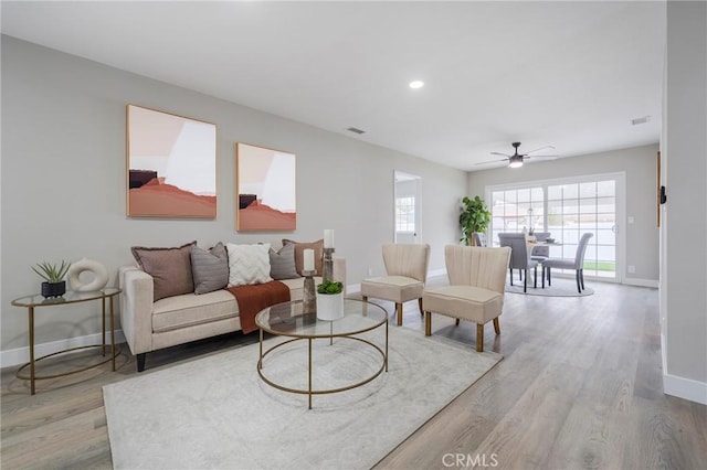 living room with visible vents, recessed lighting, wood finished floors, and baseboards