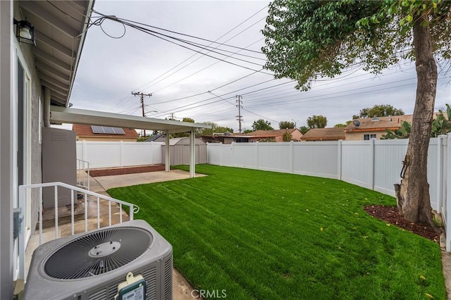 view of yard with a patio area, a fenced backyard, and central AC