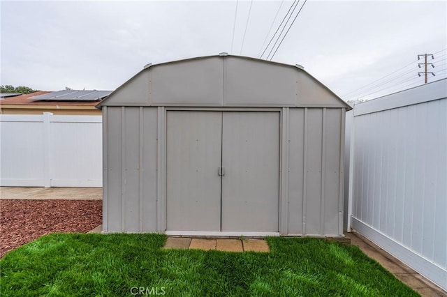 view of shed featuring fence