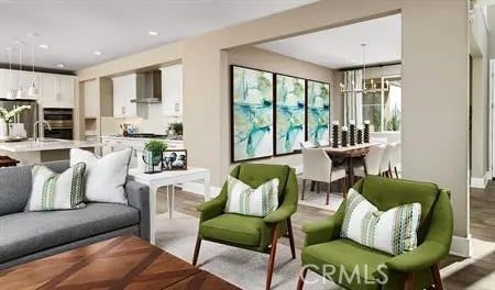 living area featuring recessed lighting and an inviting chandelier