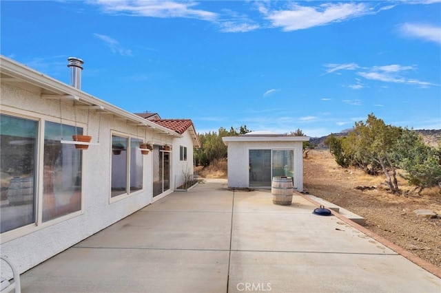 view of patio with an outbuilding