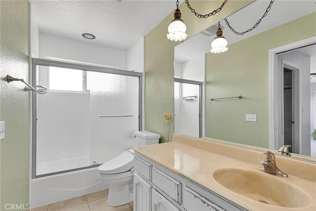 full bathroom featuring toilet, a textured ceiling, shower / bath combination with glass door, tile patterned flooring, and vanity