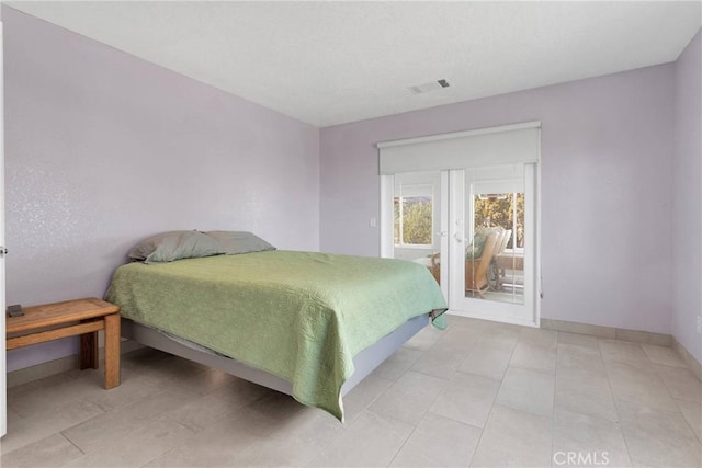 bedroom with access to exterior, baseboards, and visible vents