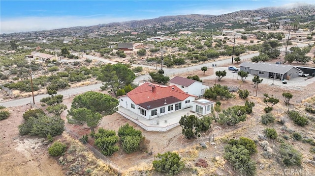 birds eye view of property with a mountain view