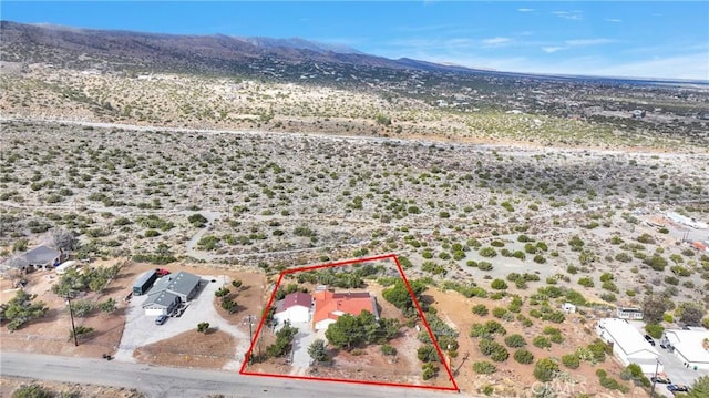 drone / aerial view featuring view of desert and a mountain view