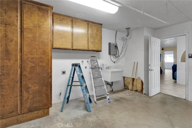 basement featuring a sink and a textured ceiling