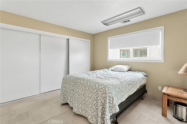 bedroom featuring a closet and visible vents