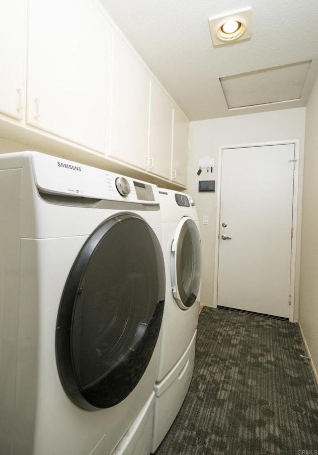 laundry area featuring cabinet space, washer and dryer, attic access, and dark colored carpet