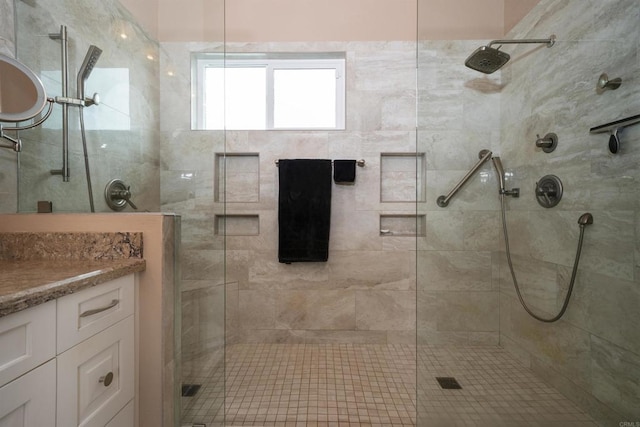 full bath with a shower stall and vanity