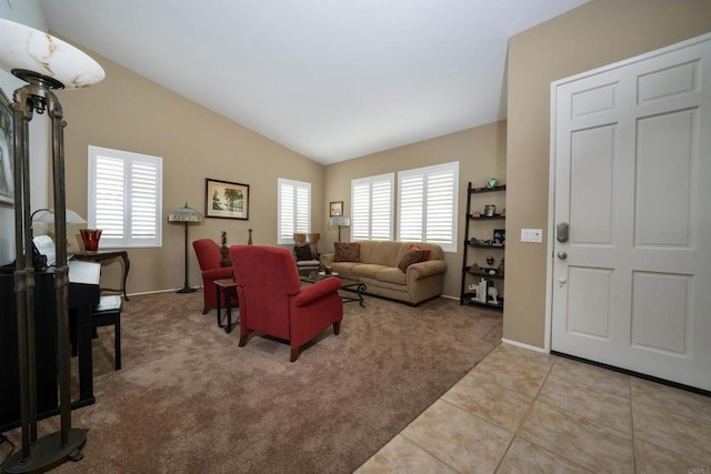 tiled living room featuring lofted ceiling, carpet flooring, a healthy amount of sunlight, and baseboards