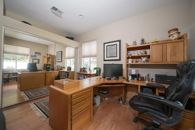 home office with visible vents and light wood-style floors