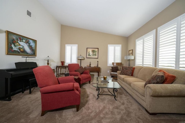 carpeted living room featuring vaulted ceiling and visible vents