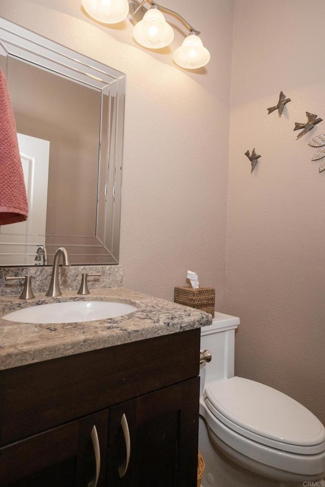 bathroom with toilet and vanity