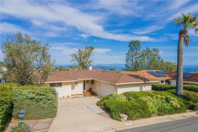 single story home featuring an attached garage, driveway, and stucco siding