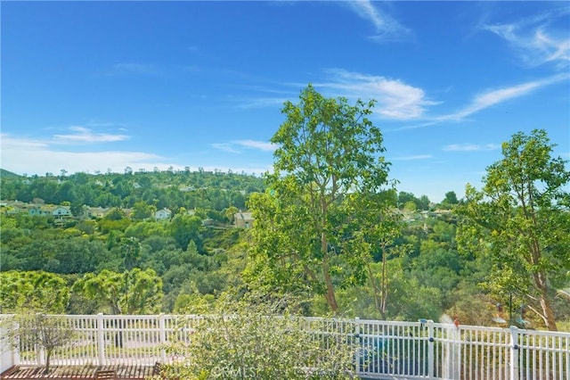 view of yard with a view of trees and fence