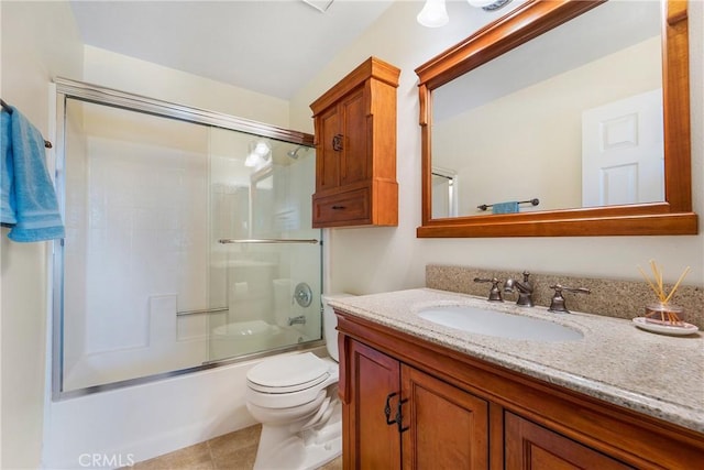 full bath with enclosed tub / shower combo, tile patterned floors, toilet, and vanity