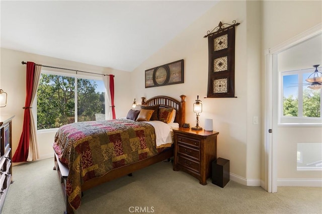 bedroom with baseboards, light carpet, and vaulted ceiling