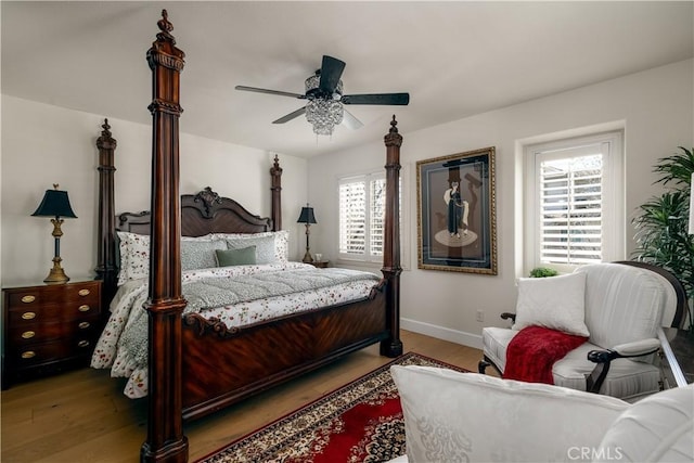 bedroom featuring ceiling fan, baseboards, and light wood-style flooring