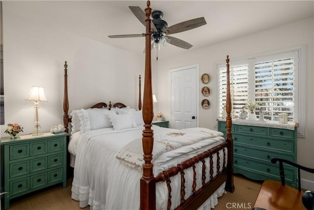 bedroom with a ceiling fan and wood finished floors