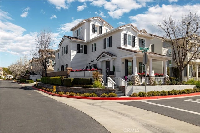 view of front of property featuring a residential view and covered porch