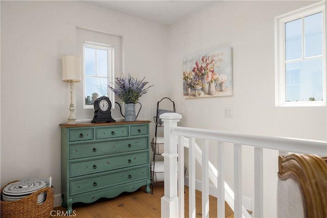 bedroom featuring multiple windows and wood finished floors