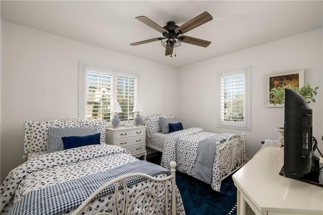 bedroom with multiple windows and a ceiling fan