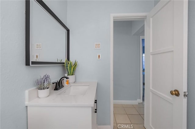 bathroom with vanity, tile patterned floors, and baseboards