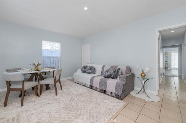 living room featuring recessed lighting, light tile patterned flooring, a healthy amount of sunlight, and baseboards