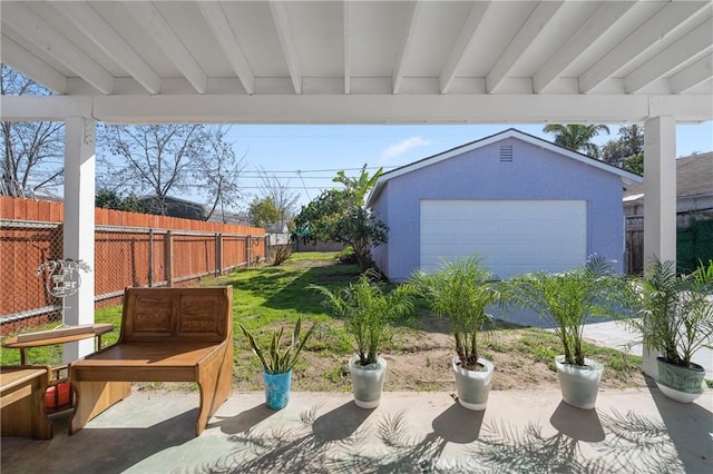 view of patio / terrace with an outdoor structure and fence