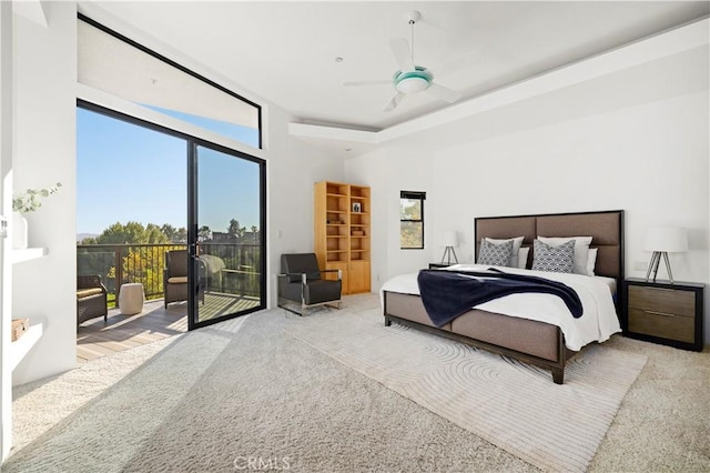 carpeted bedroom with access to exterior, a high ceiling, and ceiling fan