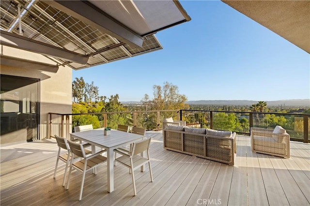 deck with outdoor dining space and outdoor lounge area