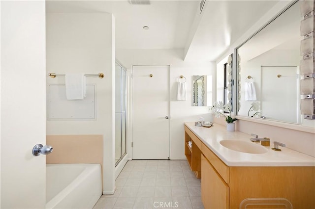 bathroom featuring vanity, a shower stall, and a tub