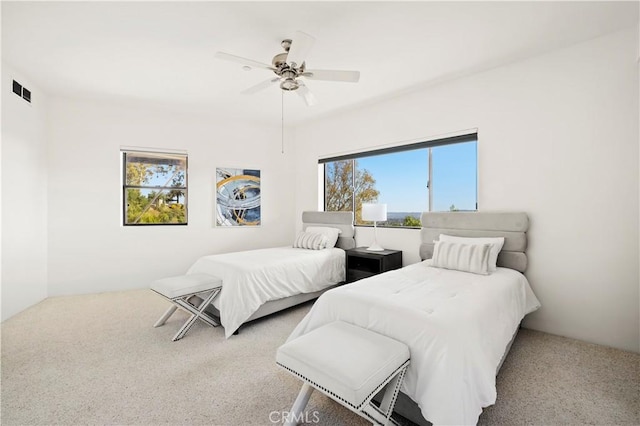 carpeted bedroom featuring visible vents and ceiling fan