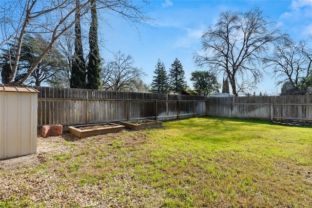 view of yard featuring a garden and a fenced backyard