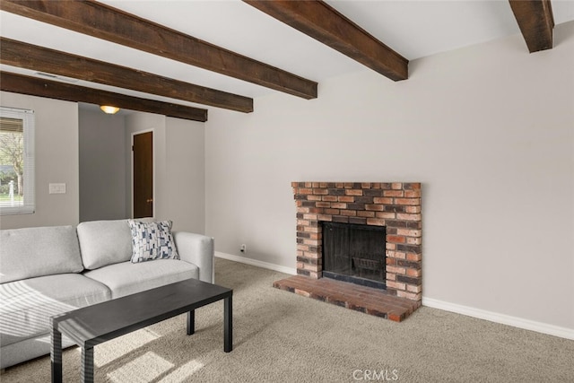 carpeted living area featuring baseboards, beam ceiling, and a fireplace