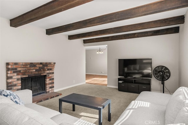 living room featuring beam ceiling, a brick fireplace, carpet, and baseboards