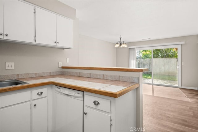 kitchen featuring light wood-style flooring, a peninsula, white cabinets, white dishwasher, and light countertops