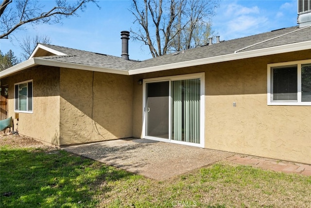 back of property featuring a patio area, stucco siding, and a shingled roof