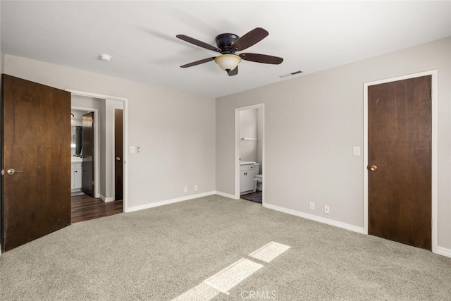 unfurnished bedroom with visible vents, ceiling fan, baseboards, carpet floors, and ensuite bathroom