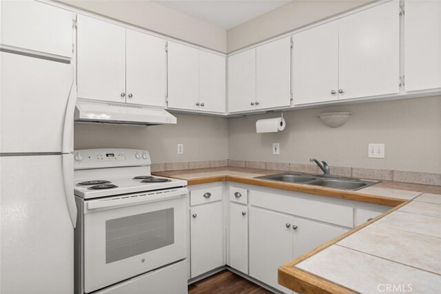 kitchen featuring under cabinet range hood, white appliances, white cabinetry, and a sink