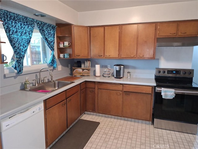 kitchen with under cabinet range hood, stainless steel electric stove, dishwasher, light countertops, and a sink