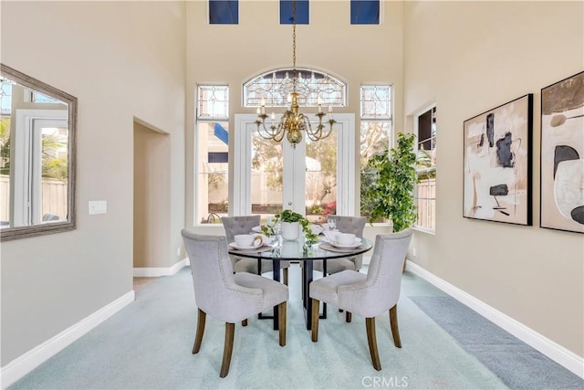 dining space with baseboards, plenty of natural light, a chandelier, and carpet flooring