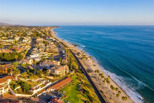 drone / aerial view featuring a beach view and a water view