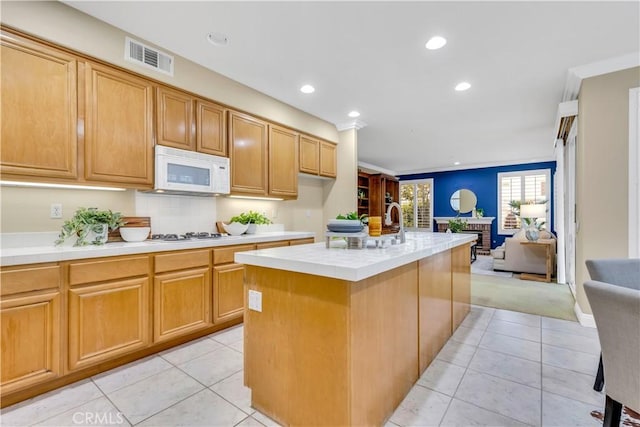 kitchen with light tile patterned floors, visible vents, white appliances, and open floor plan